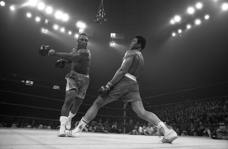 Muhammad Ali evades his great rival, Joe Frazier