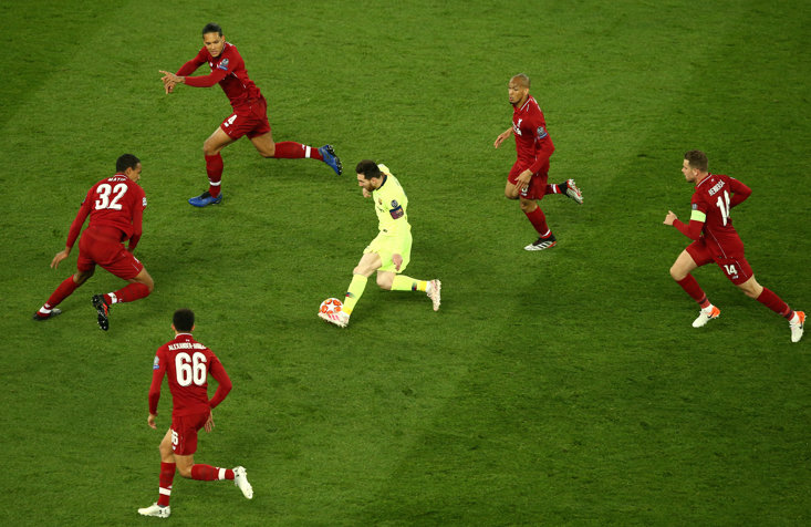 Messi swamped by Liverpool players in the Champions League